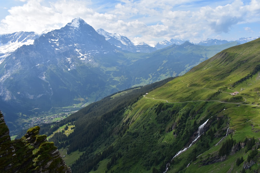 green and white mountains under white clouds during daytime