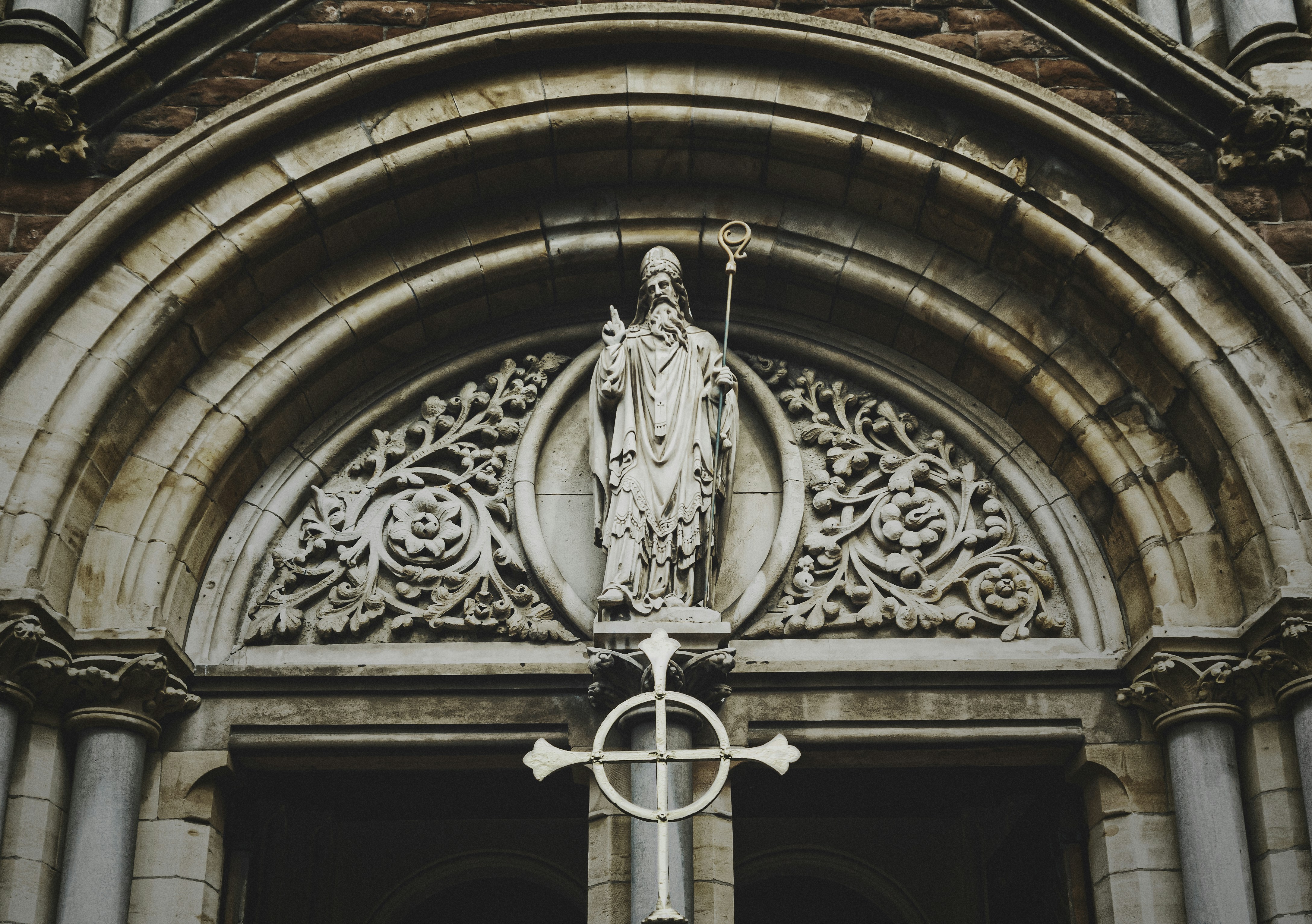 A statue of St. Patrick above the entrance to St. Patrick's Roman Catholic Church in Belfast's Cathedral Quarter in County Antrim (Aug., 2020).