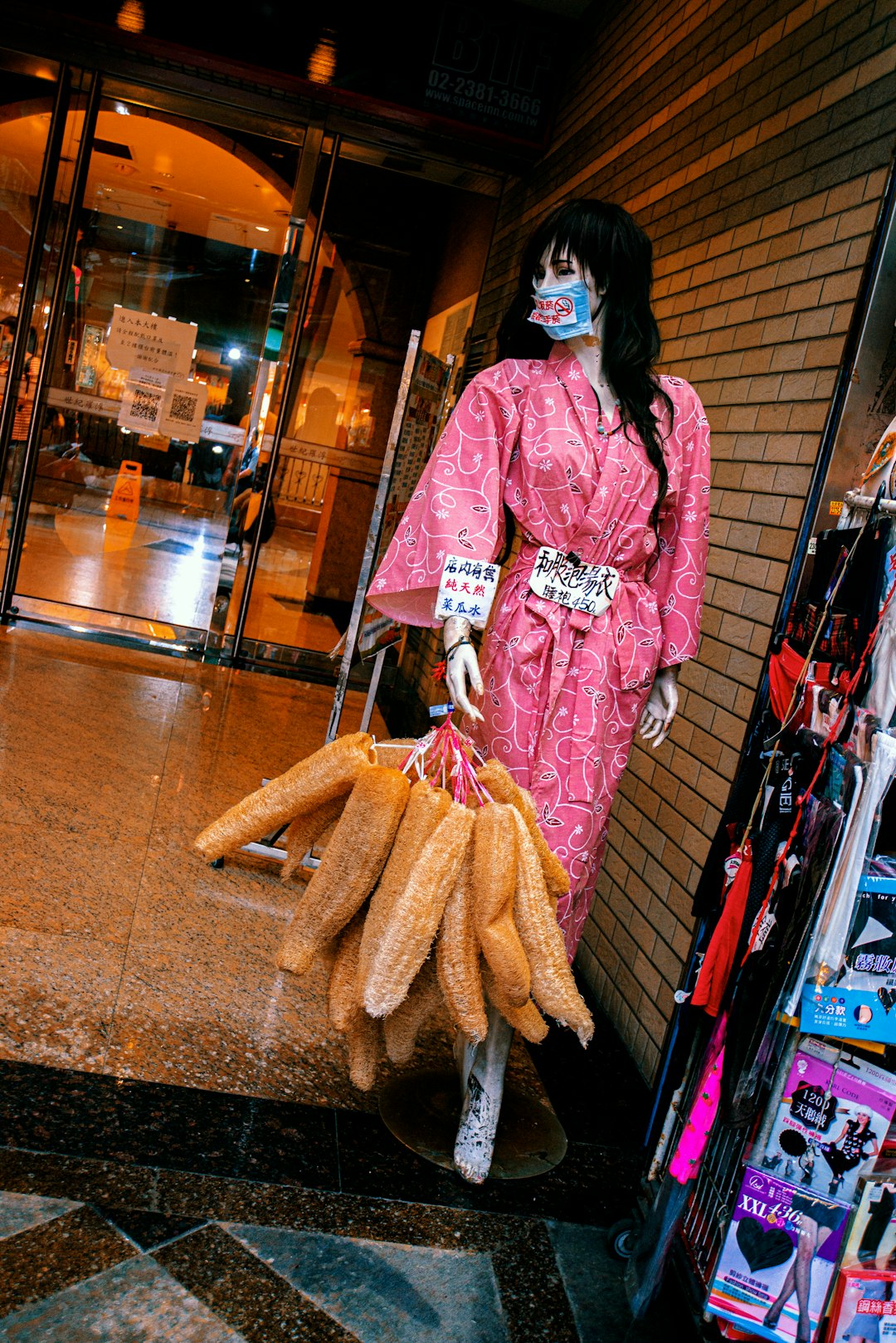 woman in pink and white kimono standing beside store