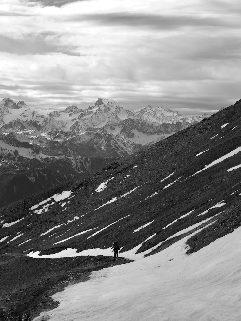 person walking on snow covered mountain