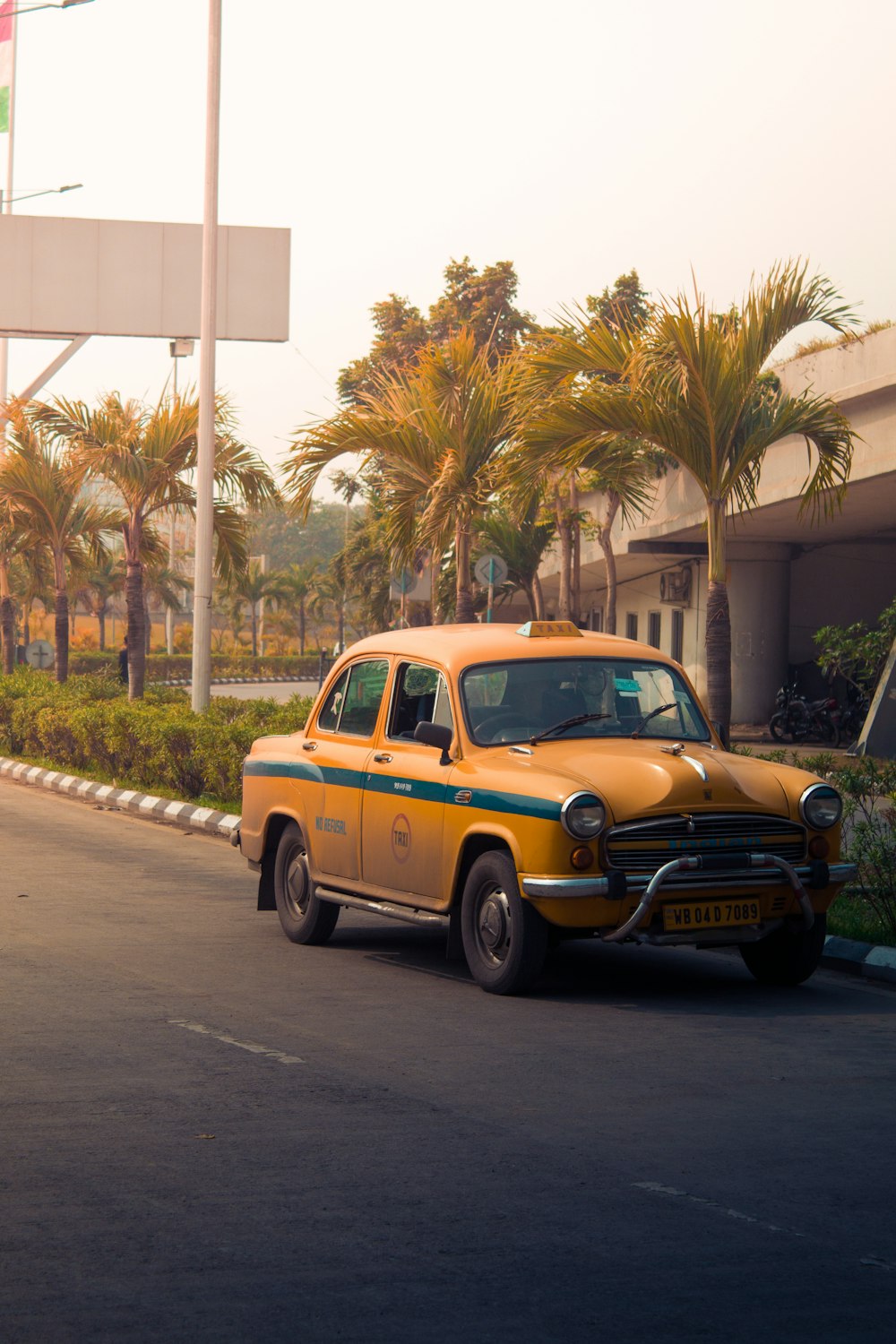 yellow taxi cab on road during daytime