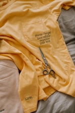 black and silver scissors on brown textile