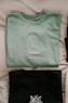 green crew neck shirt on white textile