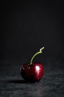 red apple fruit on black marble table