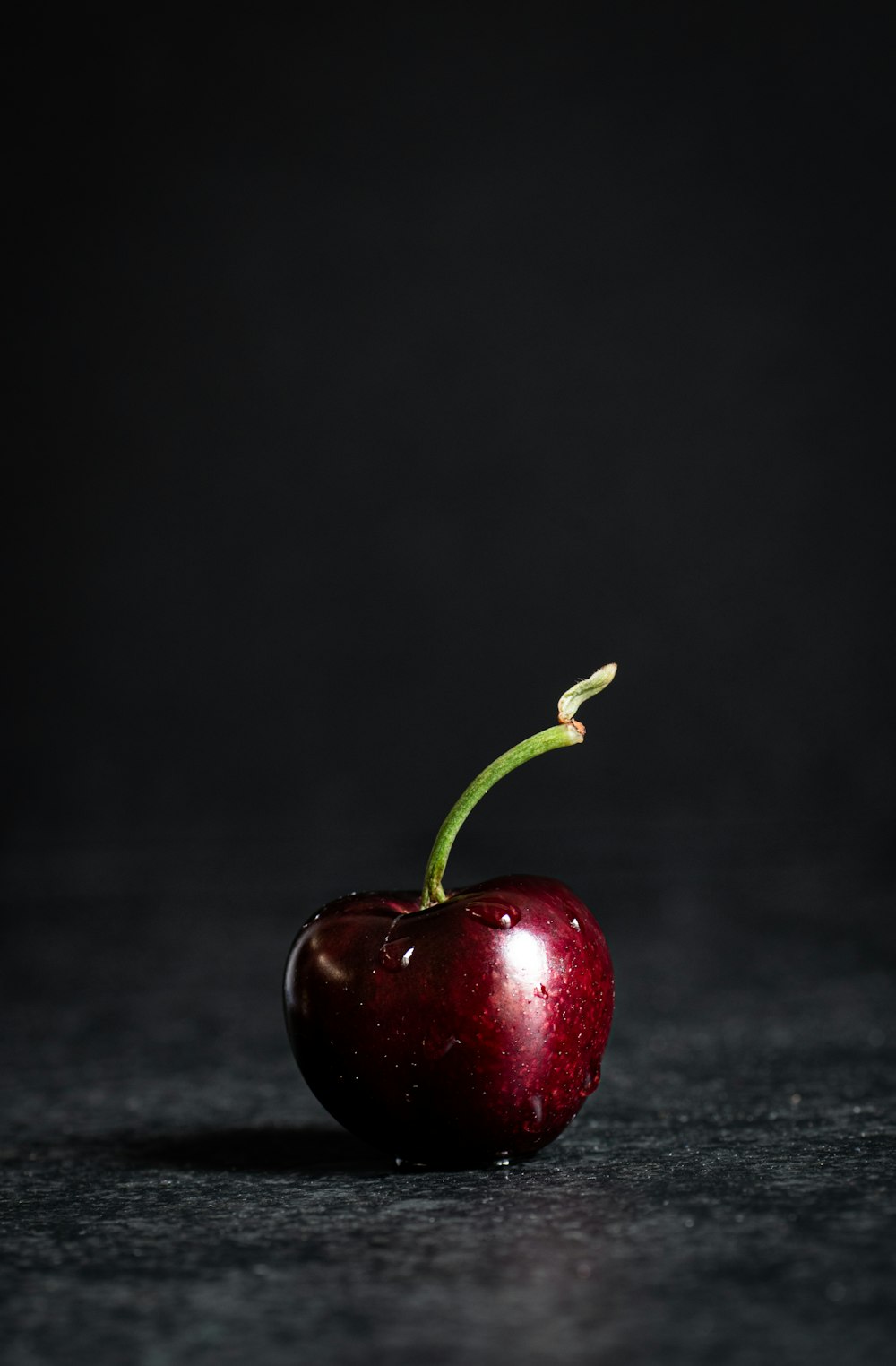 red apple fruit on black marble table