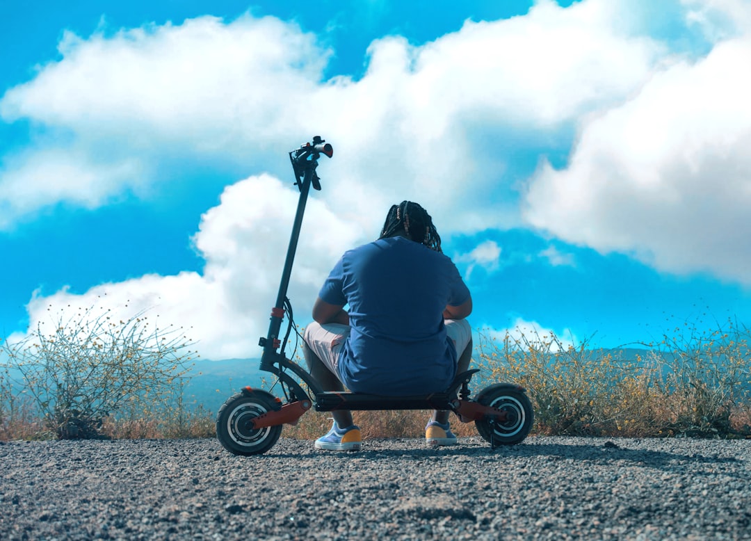 man in black hoodie riding on black and brown cart during daytime