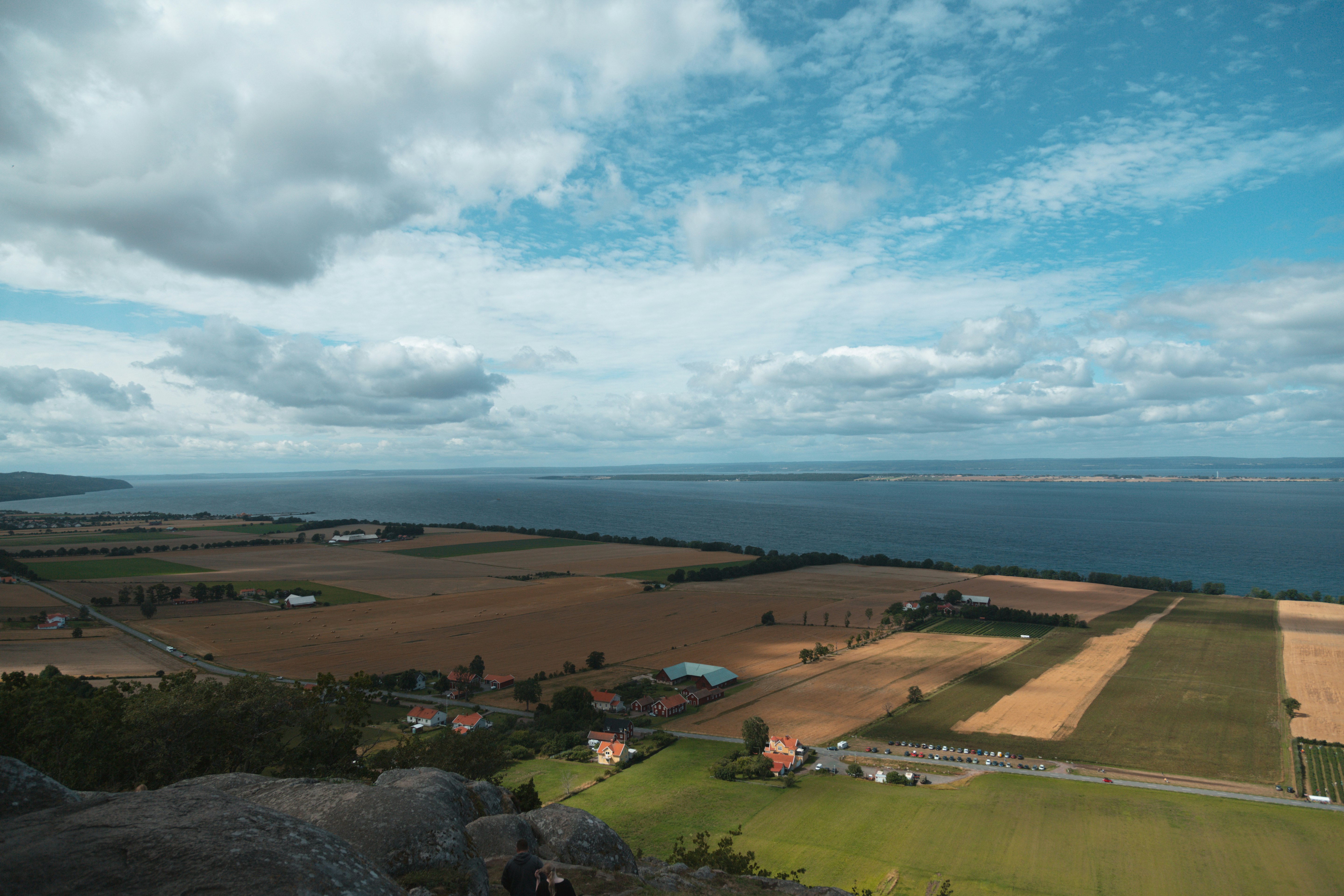 aerial view of green field under cloudy sky during daytime