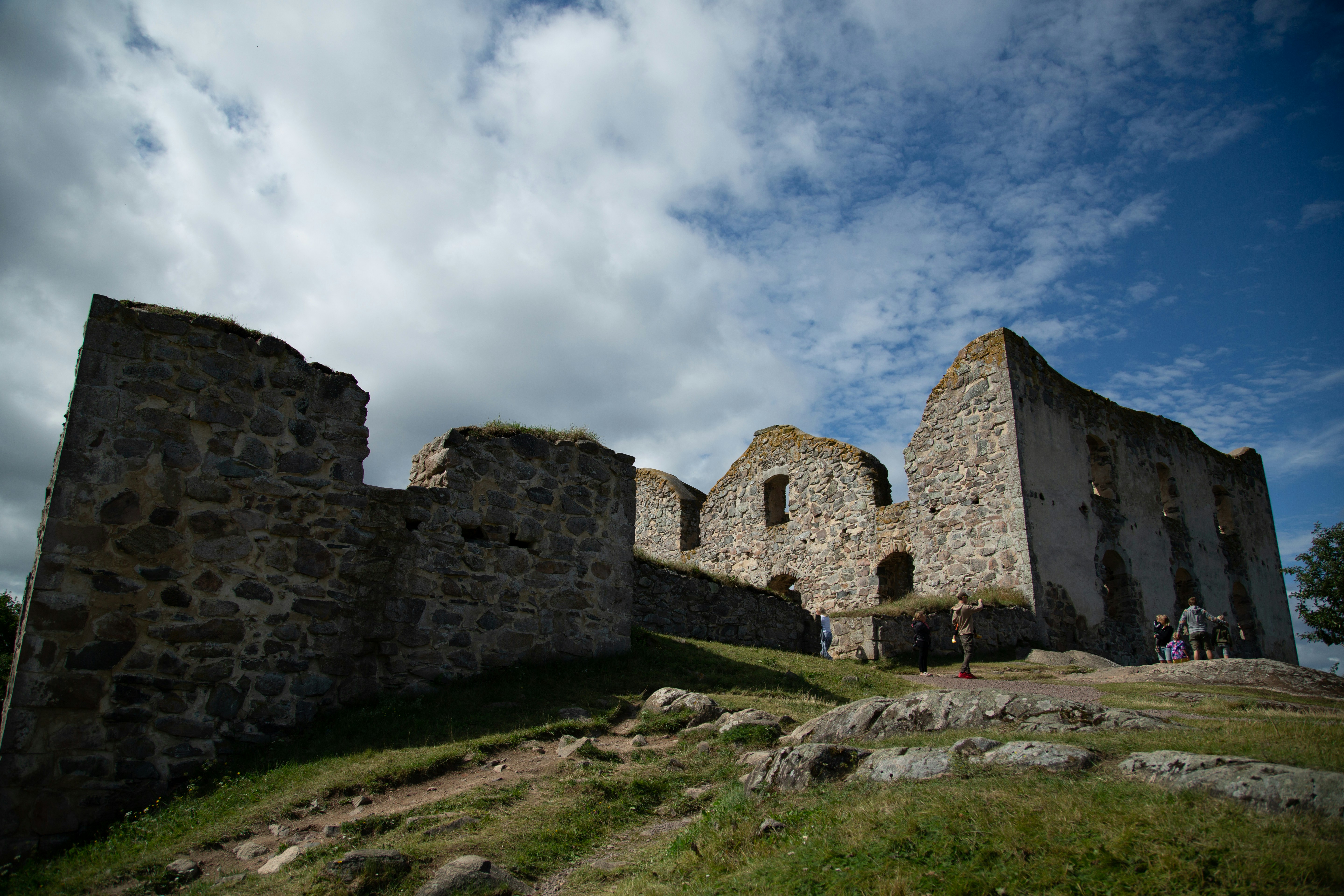 Brown brick building under cloudy sky during daytime