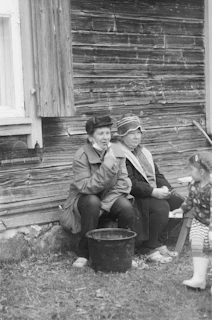 man and woman sitting on wooden bench