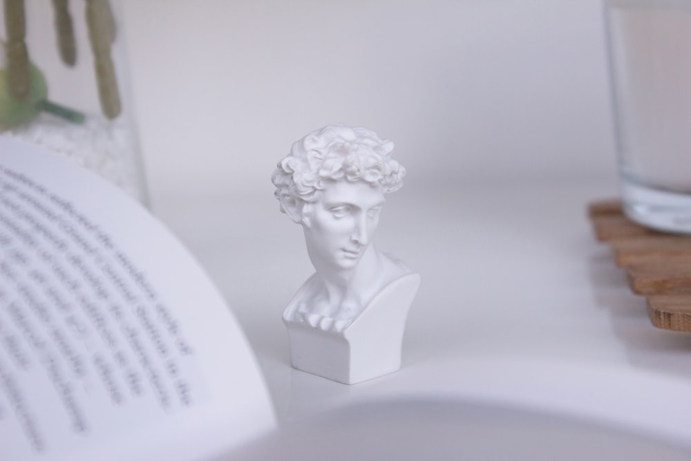 white ceramic woman figurine on white table