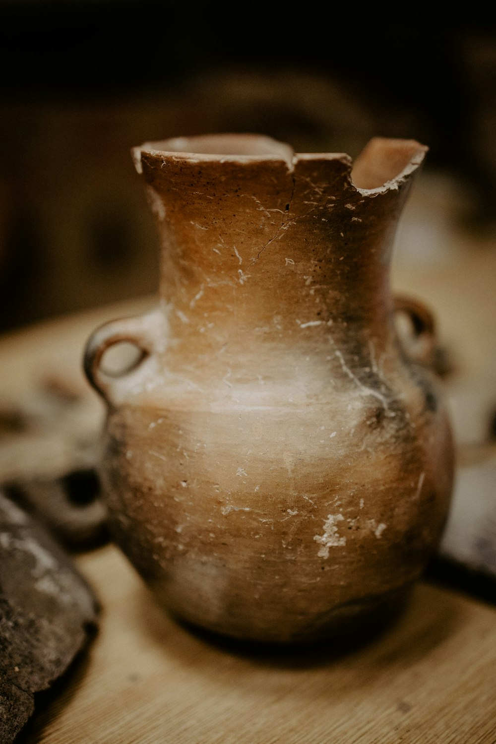 brown ceramic vase on black and white textile