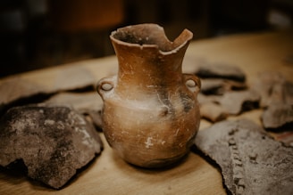 brown ceramic vase on brown wooden table