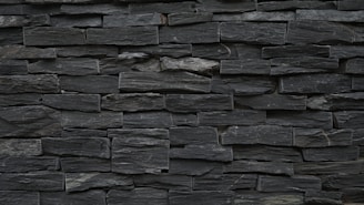 A variety of slate gray stonework products arranged aesthetically.