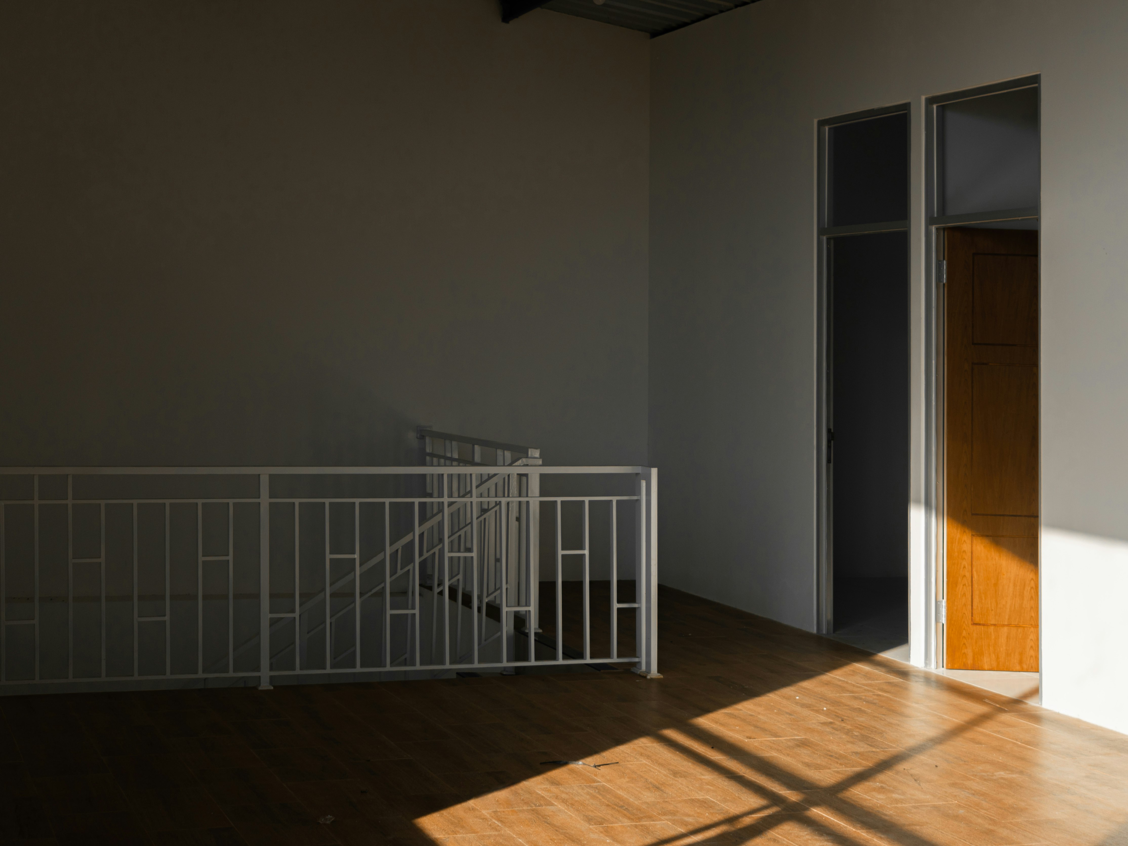 white metal railings on brown wooden floor