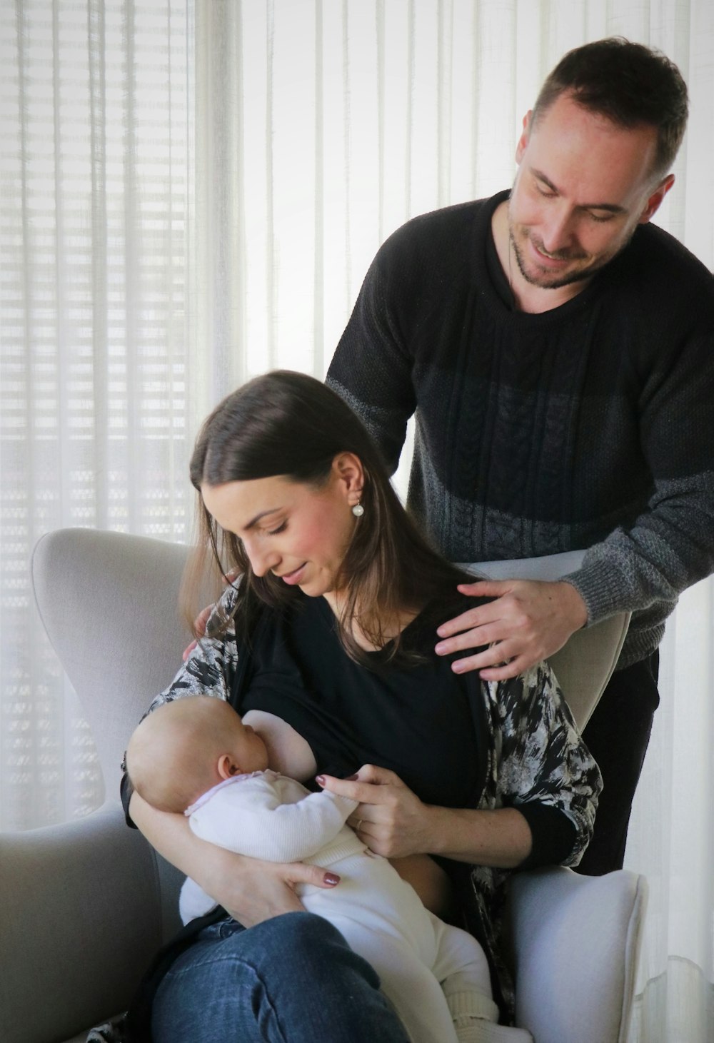 man in black sweater sitting beside woman in gray sweater