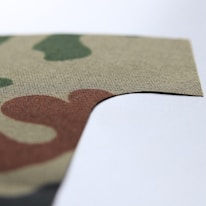 Close-up of a digital camouflage pattern blending into a gaming environment.