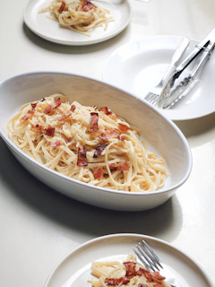 pasta dish on white ceramic bowl with cambodia premium bacon