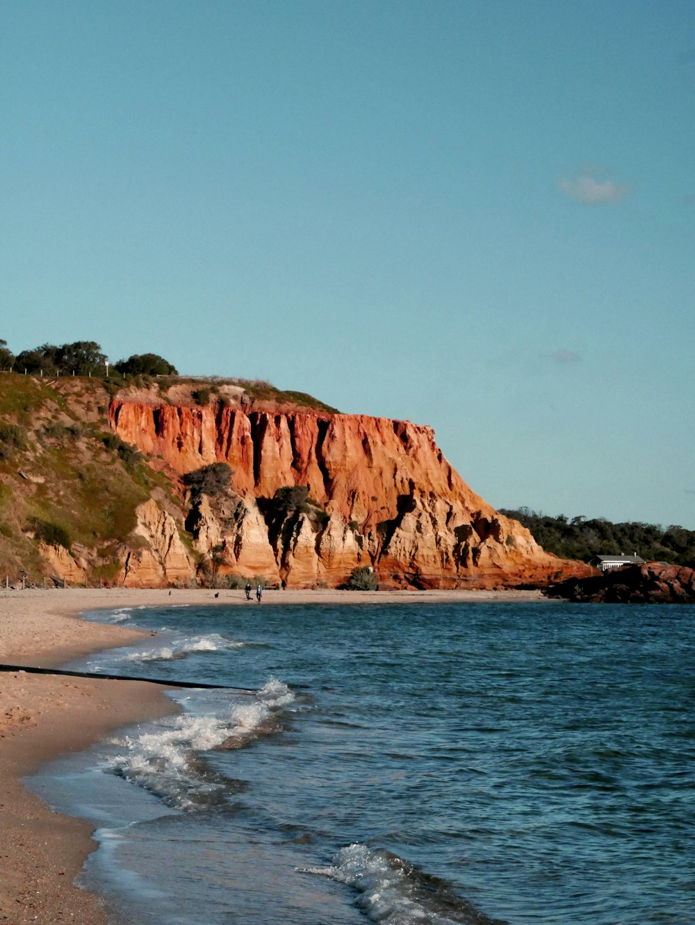 brown rock formation beside sea during daytime