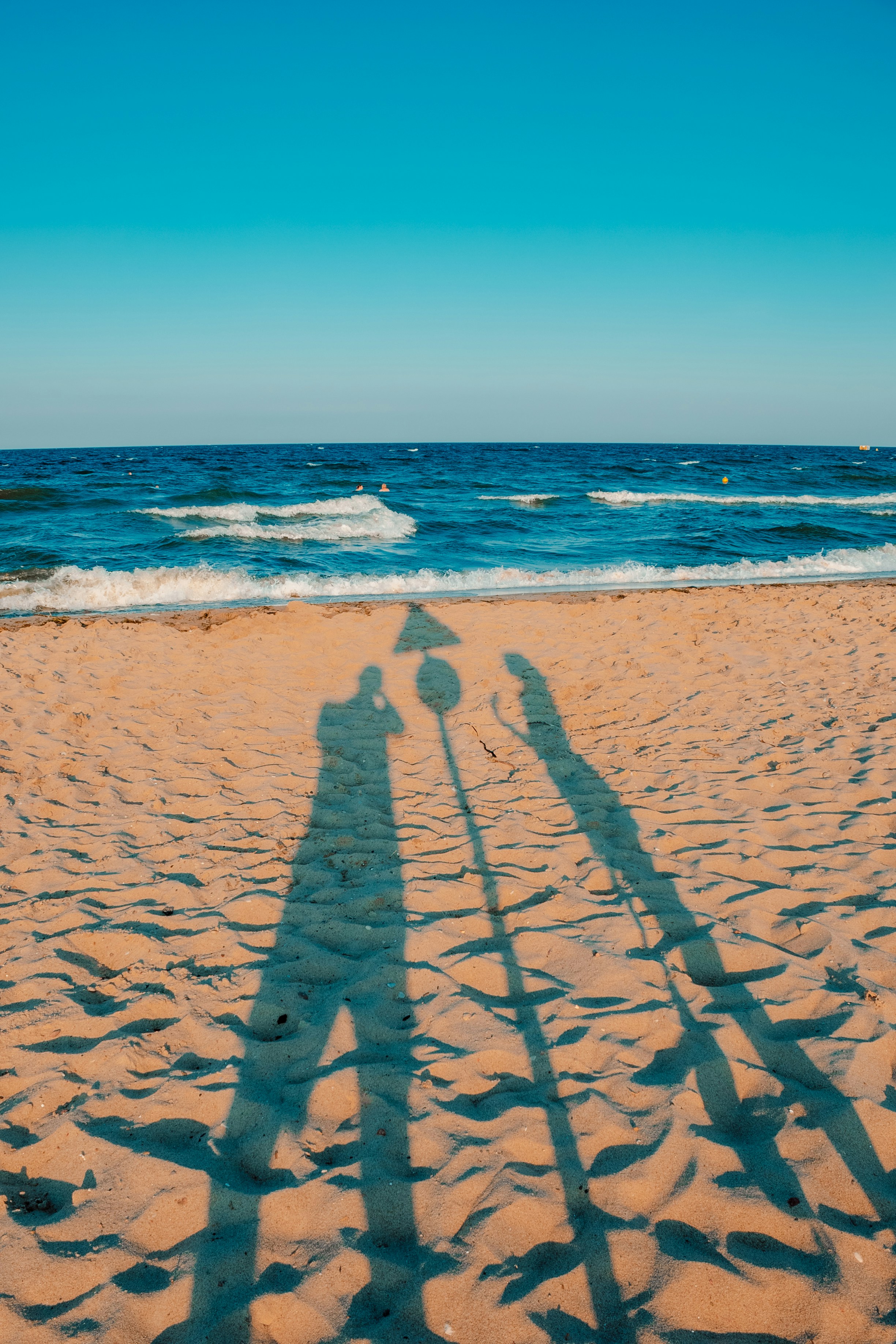 Person walking on beach during daytime