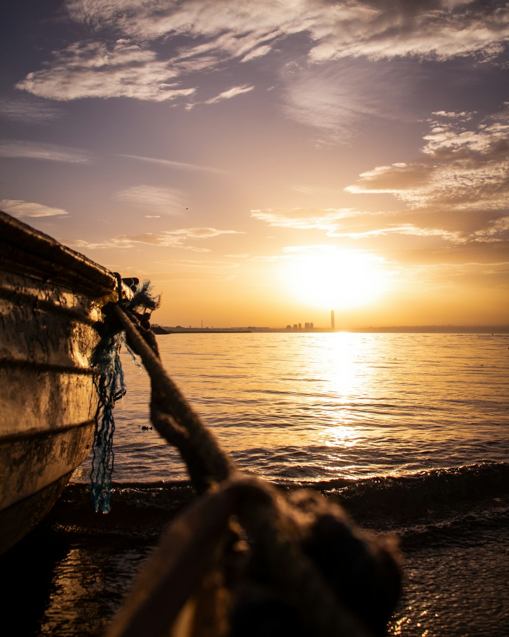 silhouette of boat on sea during sunset