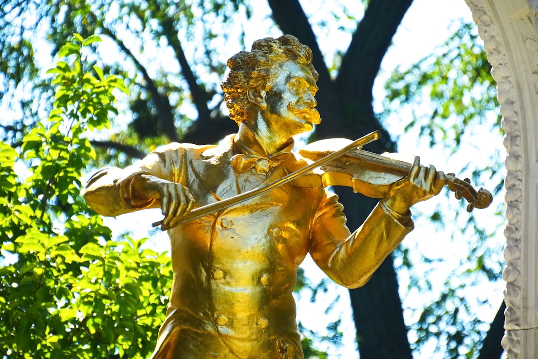 gold statue of man holding sword