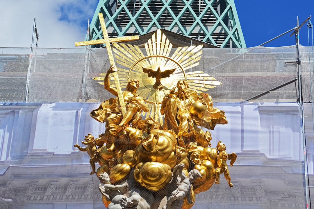 gold dragon statue near blue building during daytime