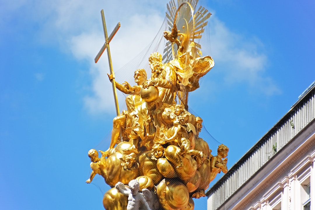 gold angel statue under blue sky during daytime