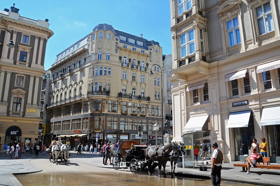 people riding horses in front of beige concrete building during daytime