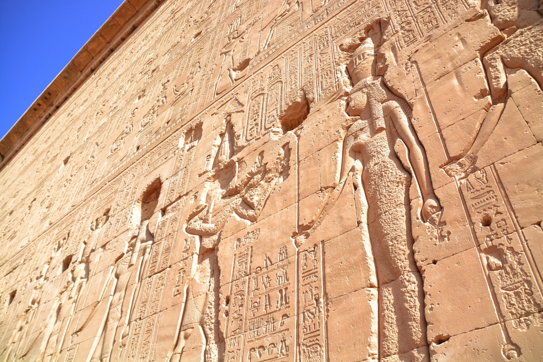 brown concrete wall with human face carved