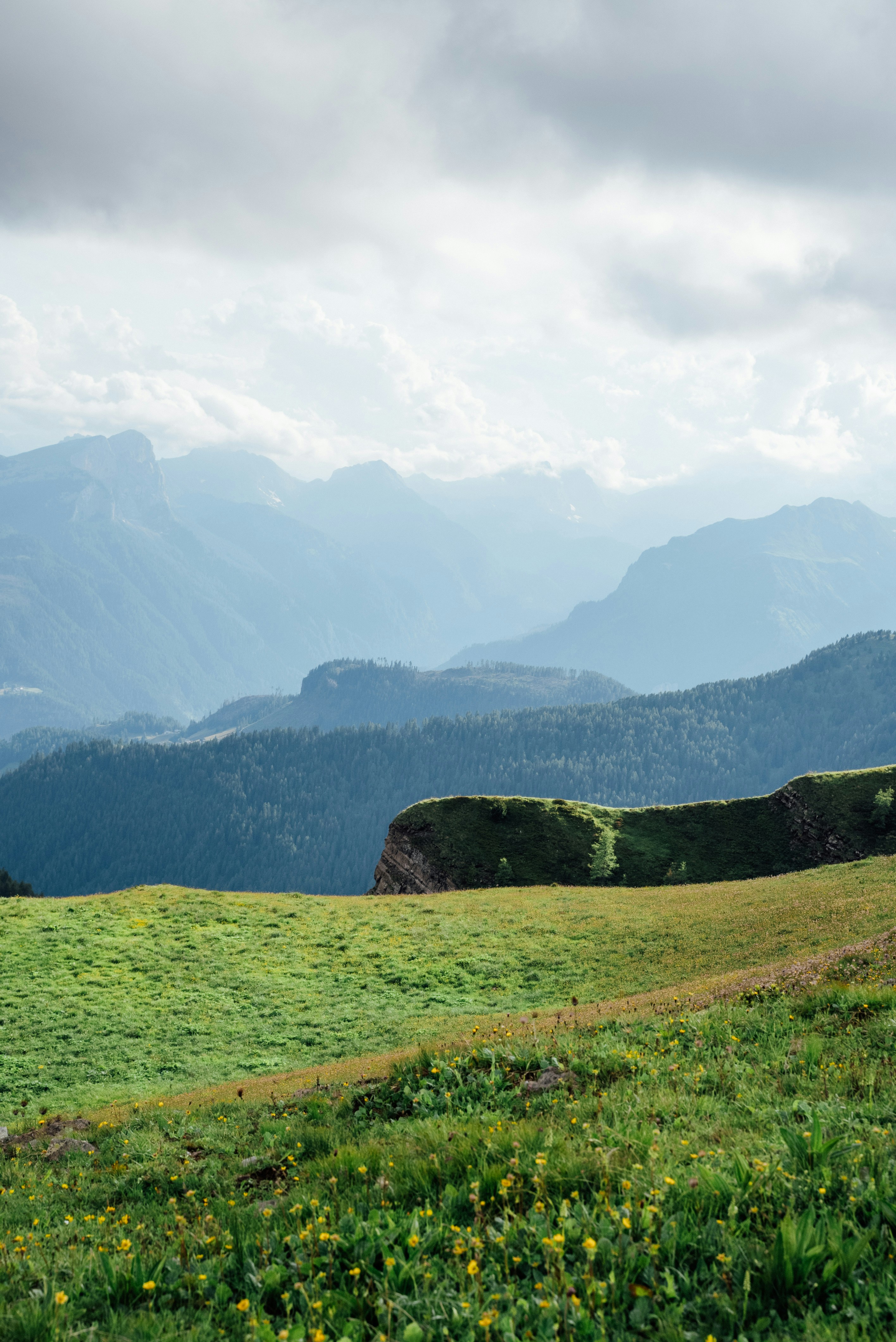 green grass field and mountains during daytime