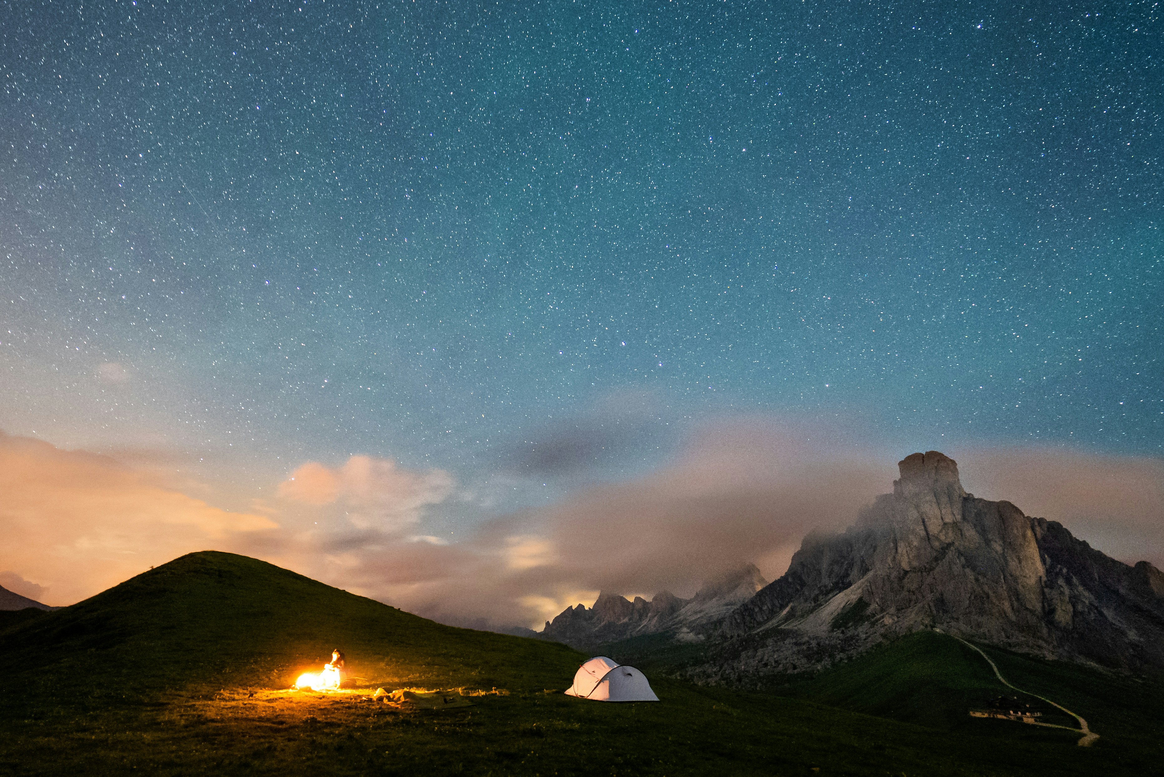 Tents set up in a mountain campsite under a starry sky
