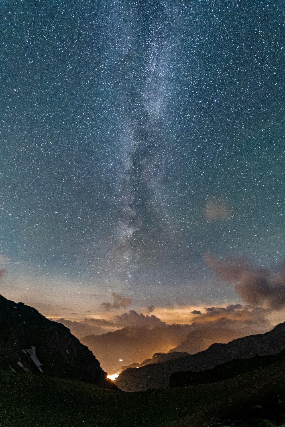 silhouette of mountain under starry night