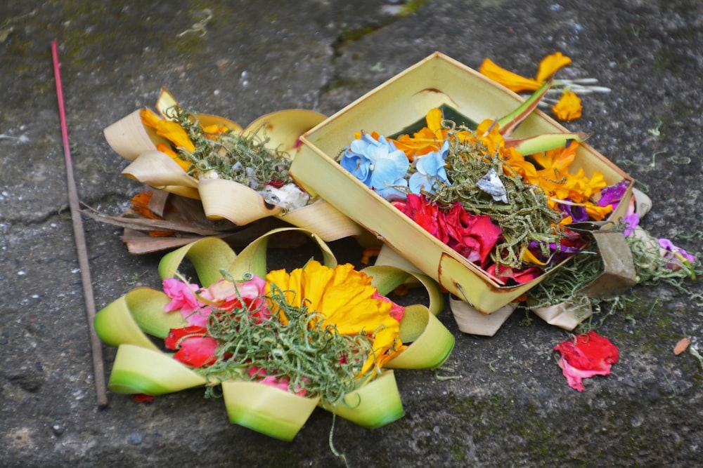 yellow and pink flowers in brown wooden box
