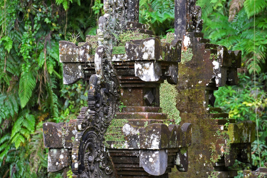 gray concrete cross on green grass