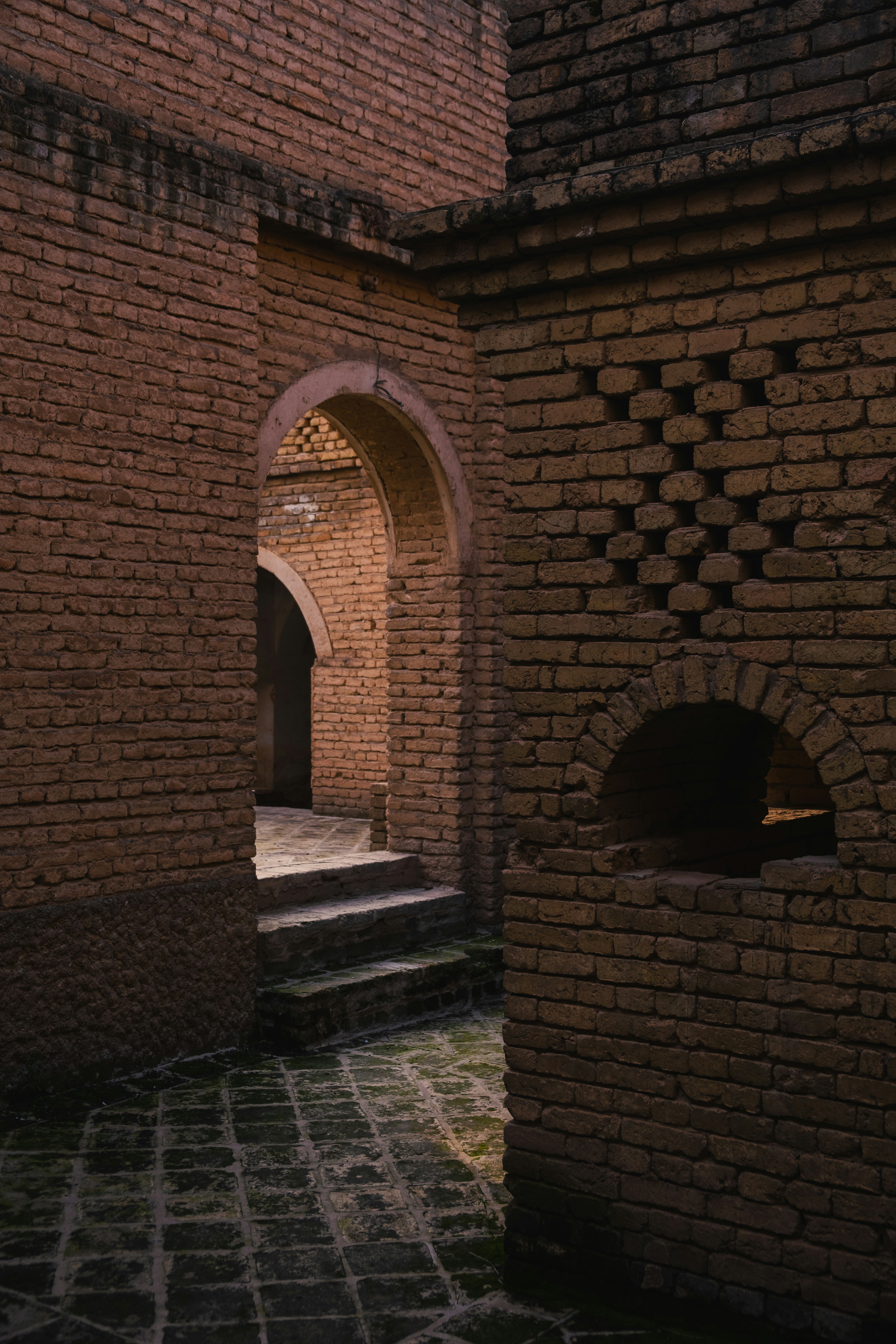 brown brick building with water