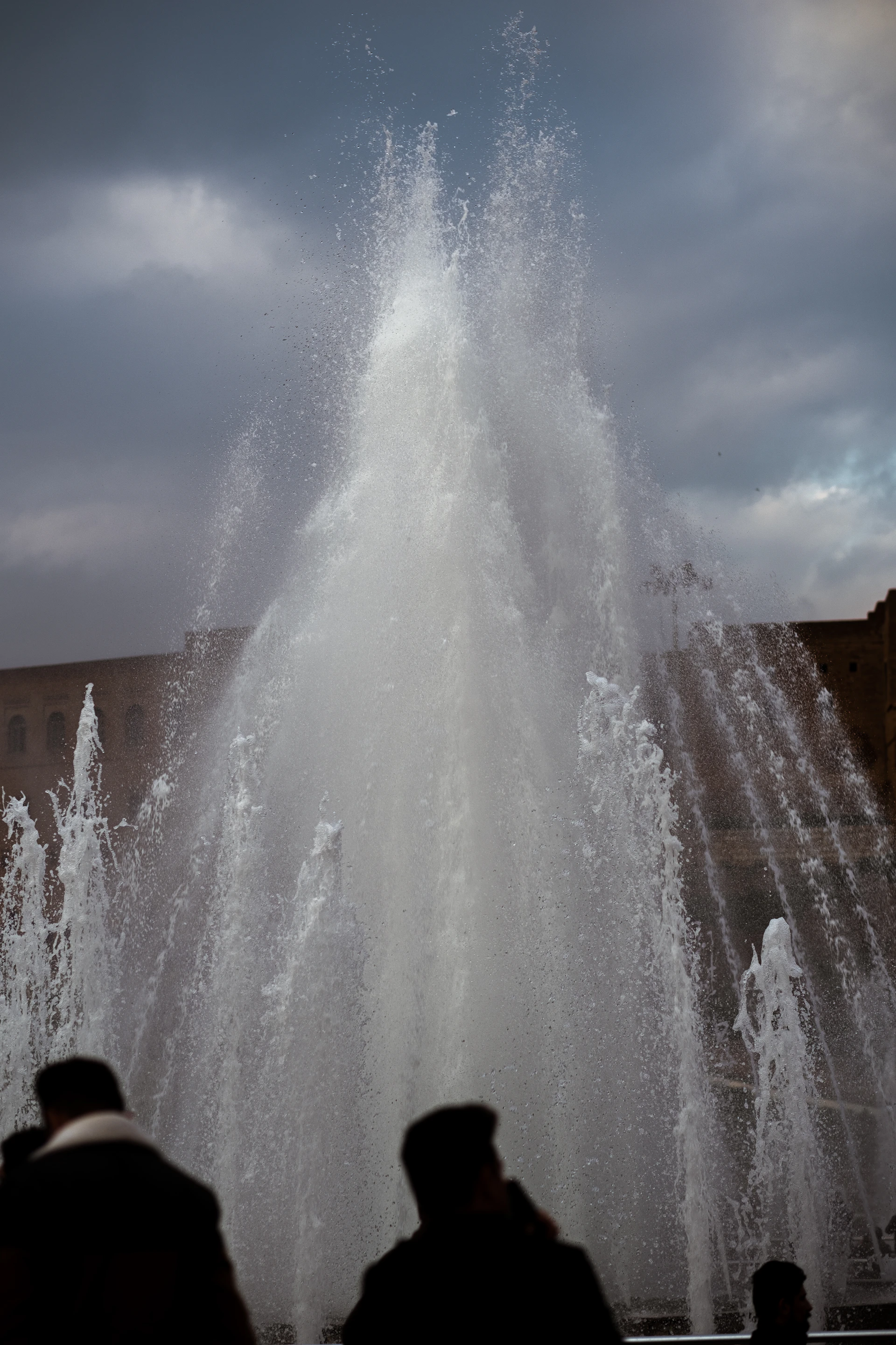 water fountain under cloudy sky during daytime