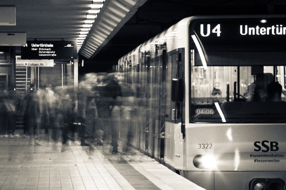 grayscale photo of train in the city