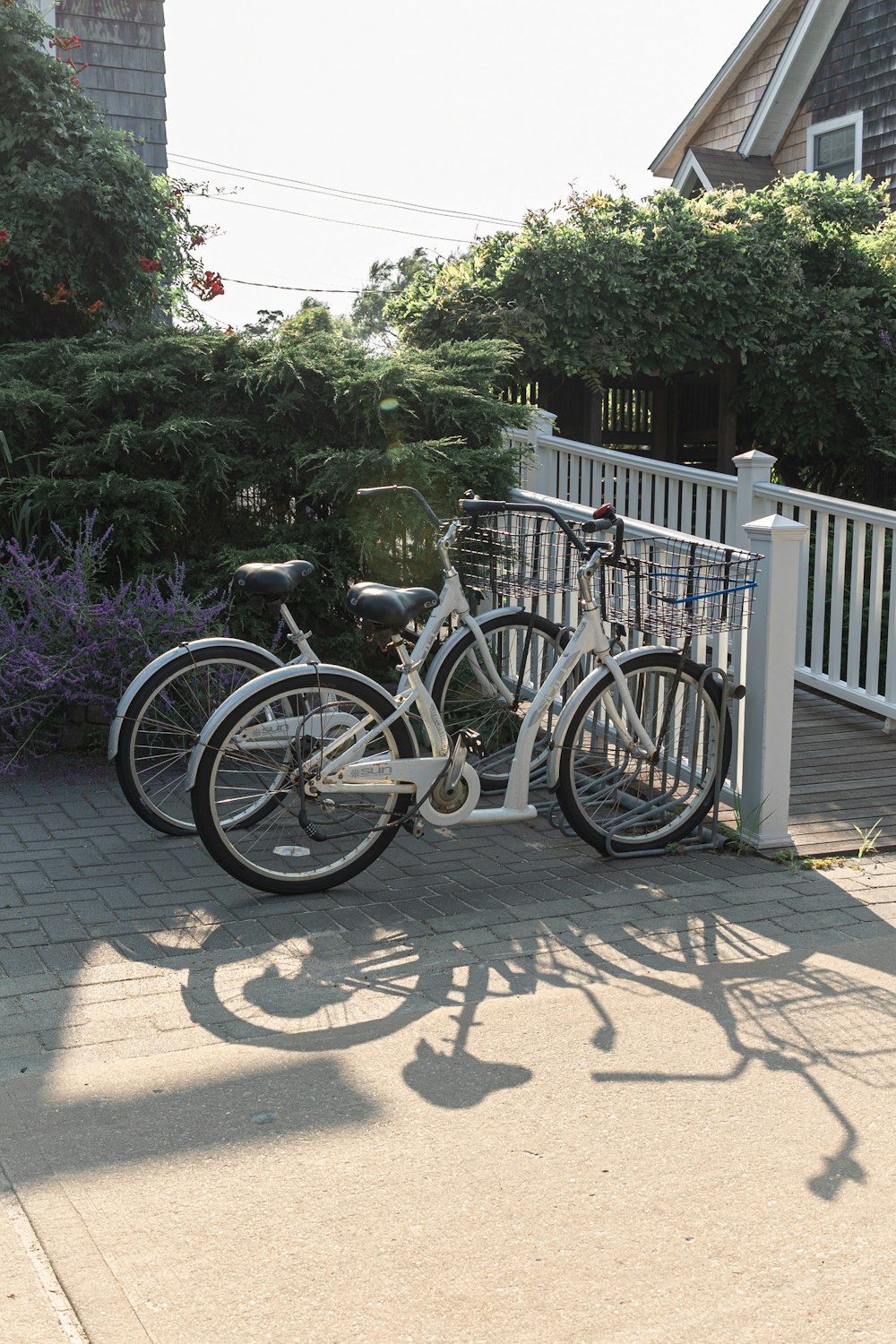 two bikes parked next to each other on a sidewalk