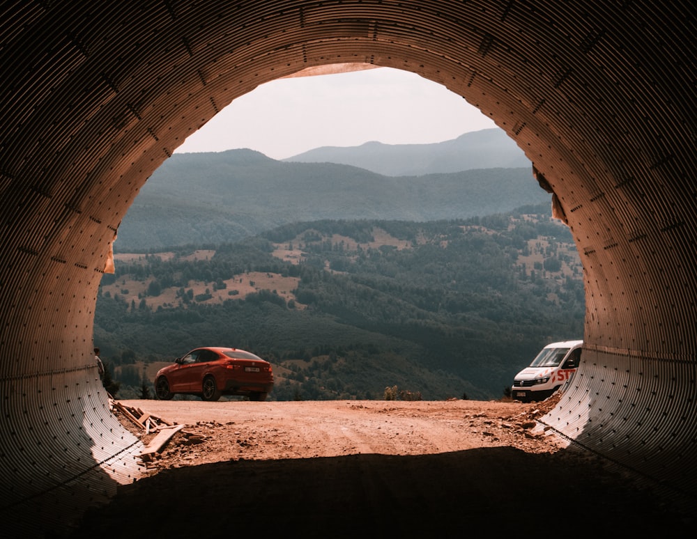 red car on brown dirt road during daytime