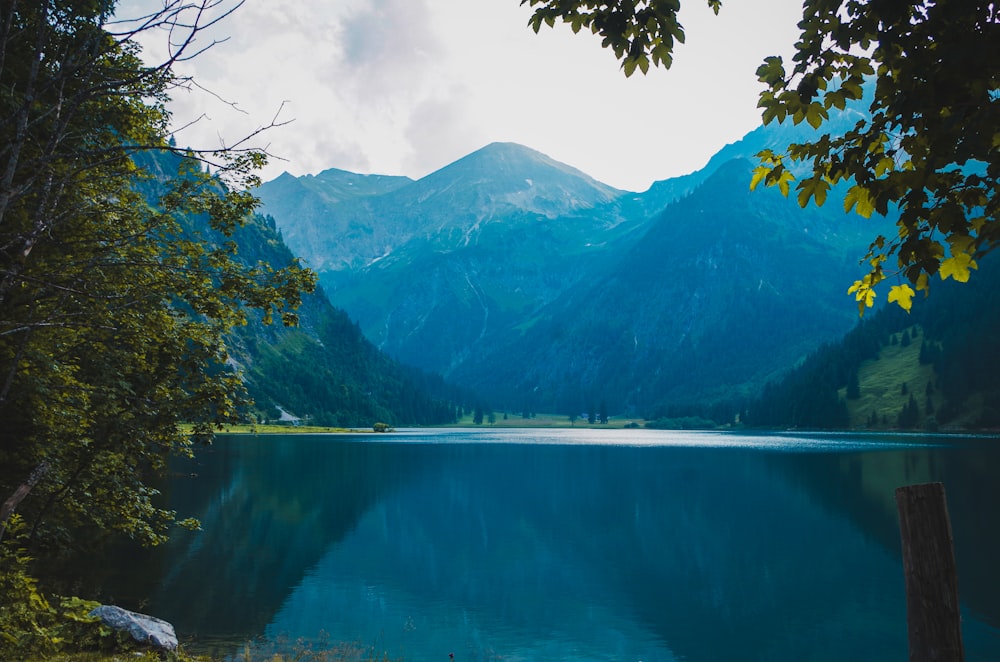 green mountains beside body of water during daytime