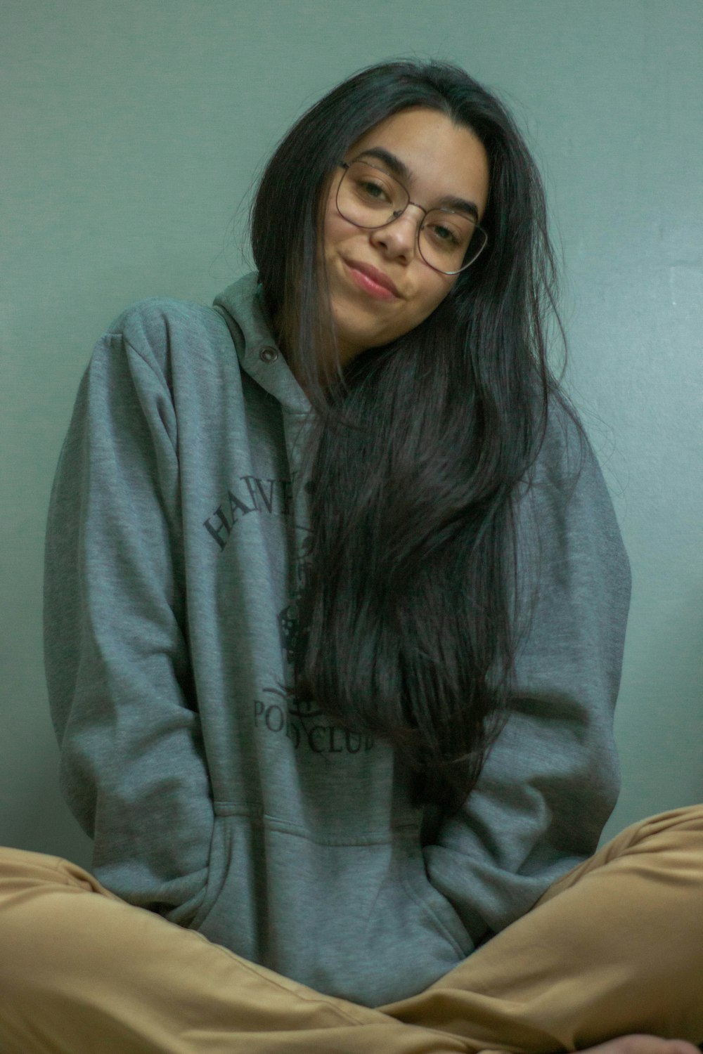 woman in gray sweater sitting on chair