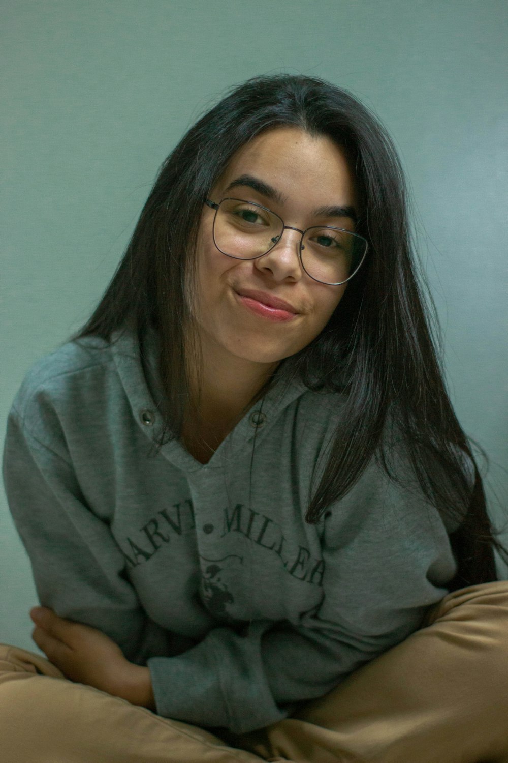 woman in gray hoodie wearing eyeglasses