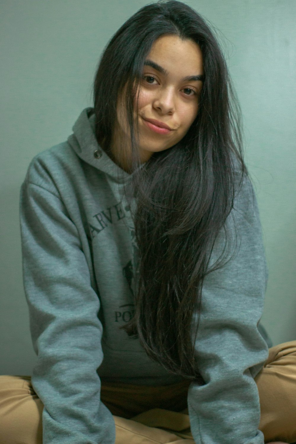 woman in gray hoodie taking selfie