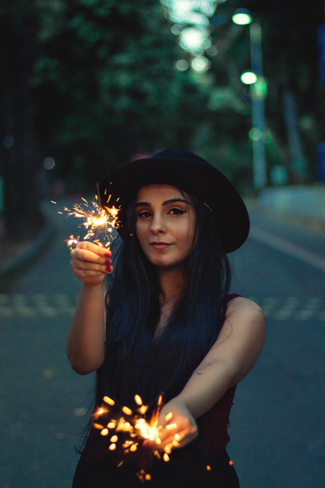 woman in black tank top holding sparkler