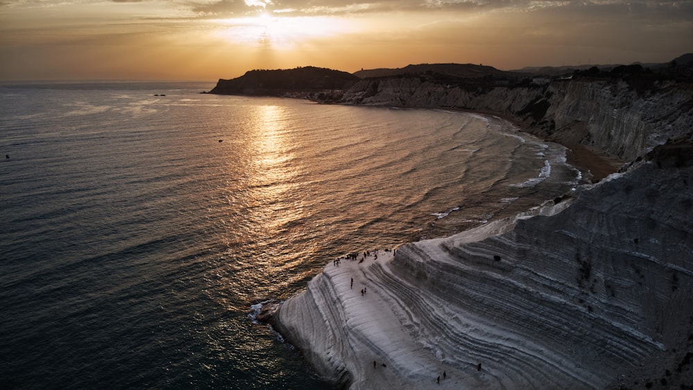 ocean waves crashing on shore during sunset