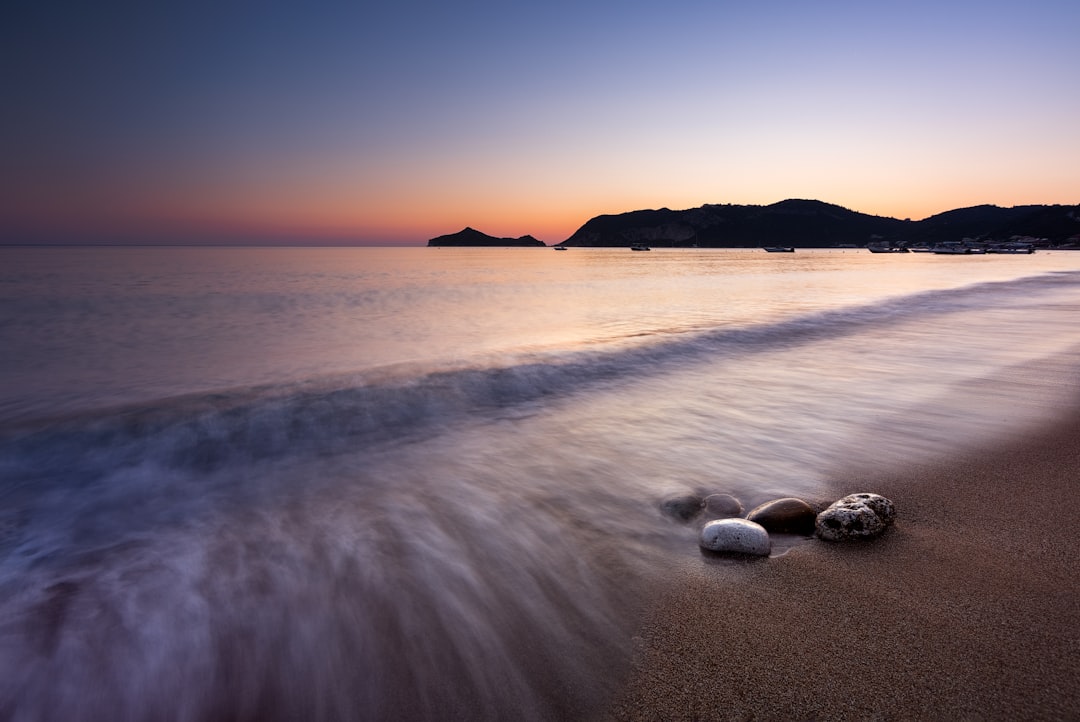 white stones on seashore during sunset