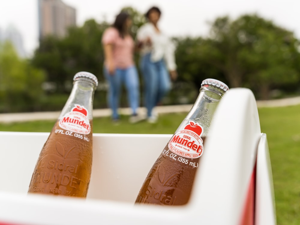 coca cola glass bottle on white ceramic sink