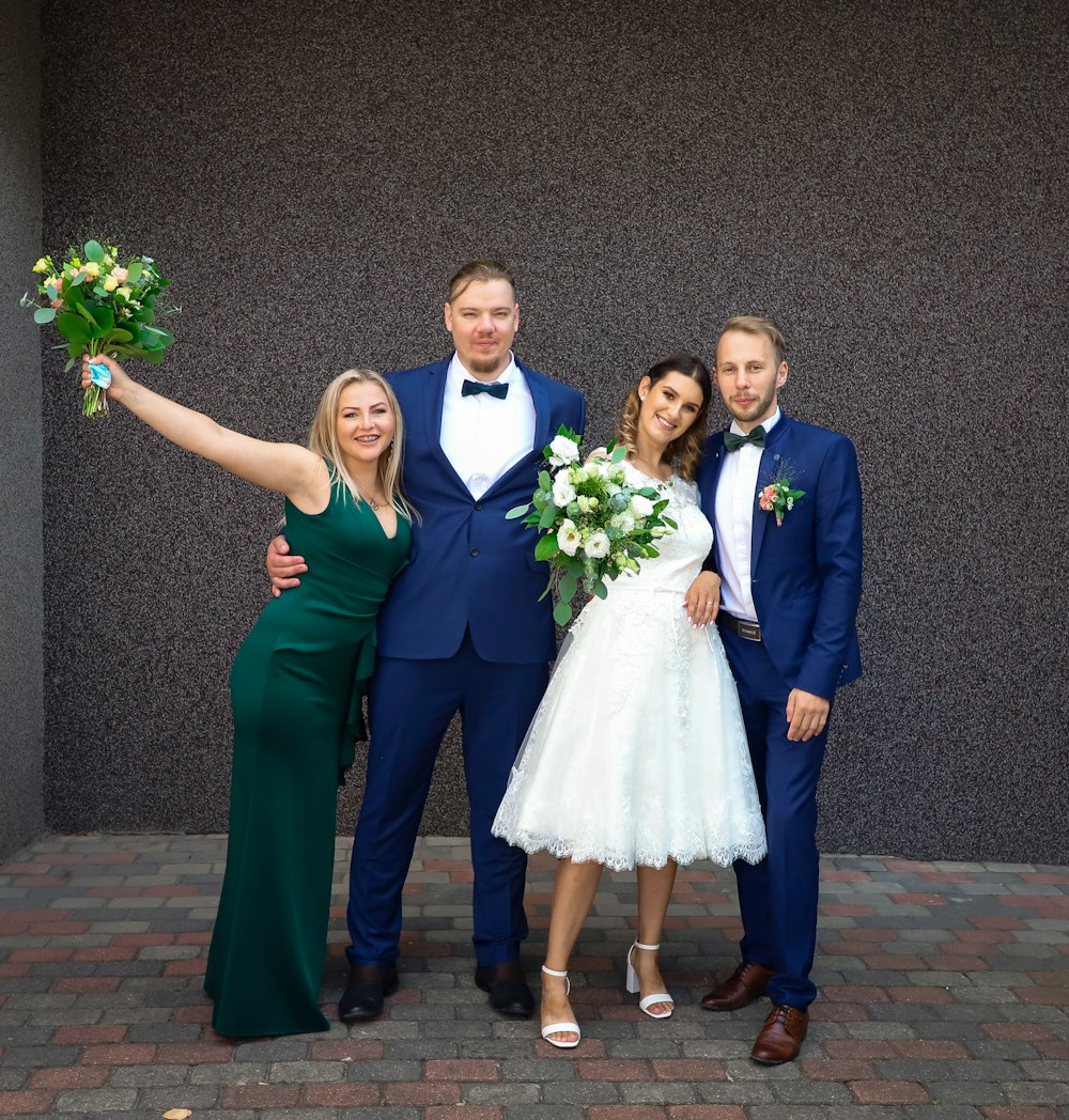 man in blue suit jacket standing beside woman in white dress