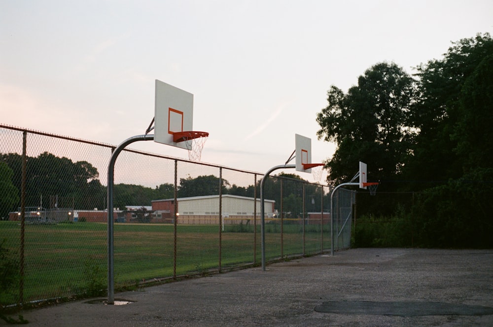 basketball hoop on green grass field during daytime