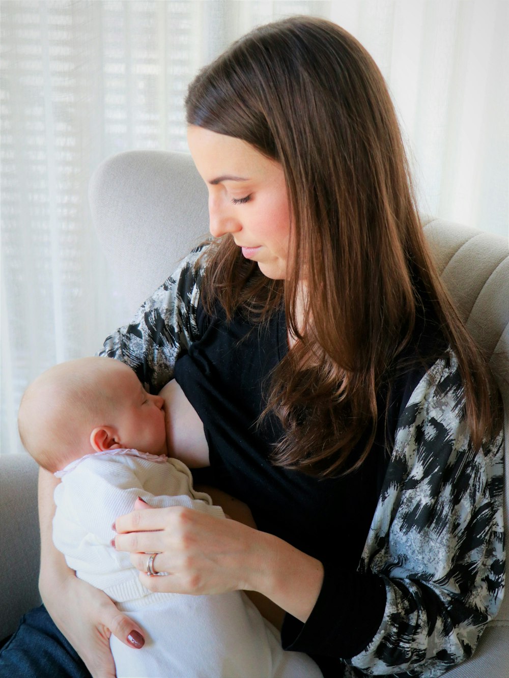woman in black shirt holding baby